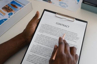 high-angle-man-reading-contract high-angle-man-reading-contract